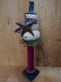 Snowman atop bobbin